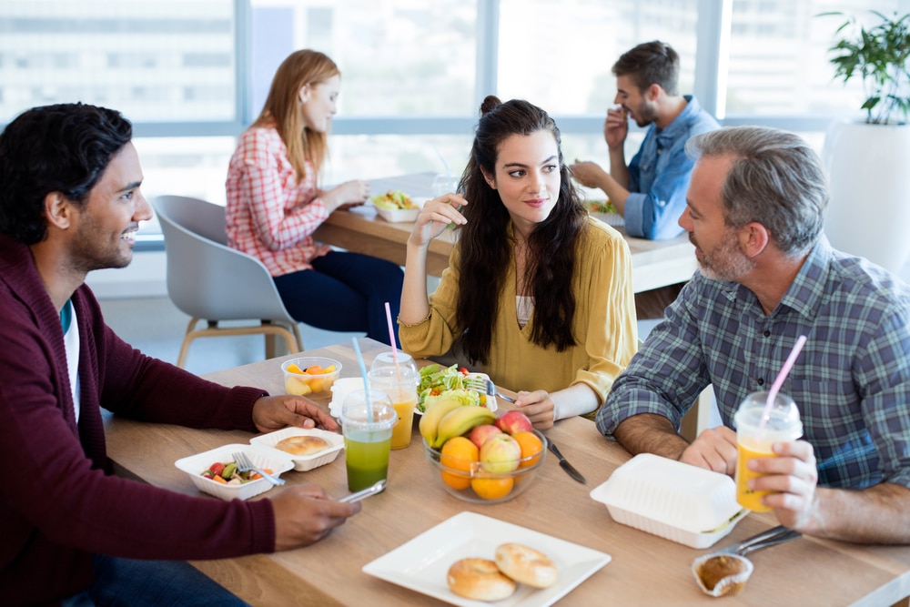 Creative,Business,Team,Discussing,While,Having,Meal,In,Office